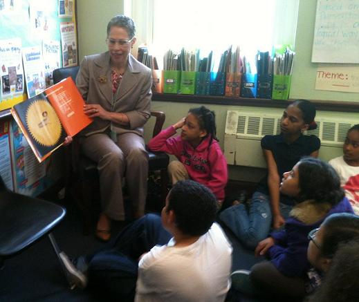 Susan Windham-Bannister, Massachusetts Life Sciences Center's President & CEO, reads "Math Curse" by Jon Scieszka and Lane Smith to students during the 3rd Annual Special Guest Reader Day at Mather Elementary in Boston.