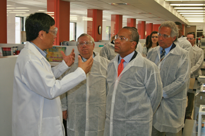 Dr. Jesse Dong (left), Vice President of Compound Discovery and Research at Ipsen Biomeasure, provides a tour of the company’s lab facilities to, from left to right, State Senator Richard Moore, Governor Deval Patrick, and State Representative John Fernandes.