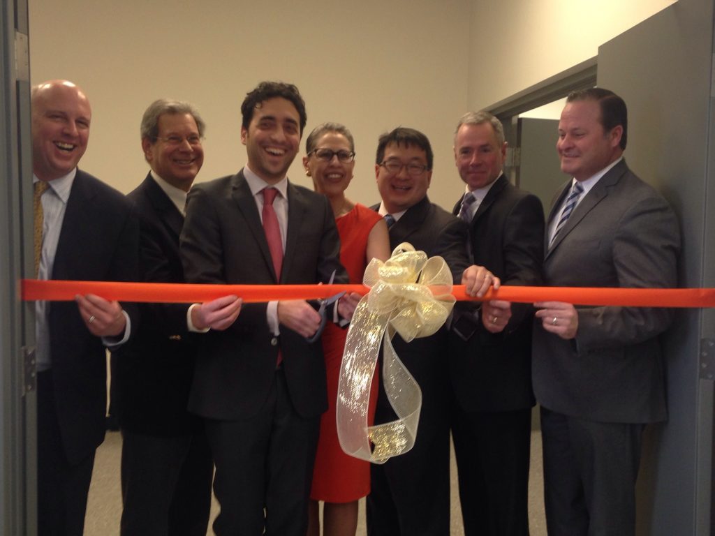 (From left to right) Assistant Secretary for Business Growth at the Executive Office of Housing and Economic Development Michael Kennealy, State Representative Jay Kaufman (D-Lexington), CONTINUUS CEO Dr. Salvatore Mascia, MLSC President & CEO Susan Windham-Bannister, CONTINUUS Co-Founder & Chief Business Officer Bayan Takizawa, Woburn Mayor Scott Galvin and President & CEO of MassBio Bob Coughlin participate in a ribbon-cutting to celebrate the official opening of CONTINUUS’ new facility in Woburn.